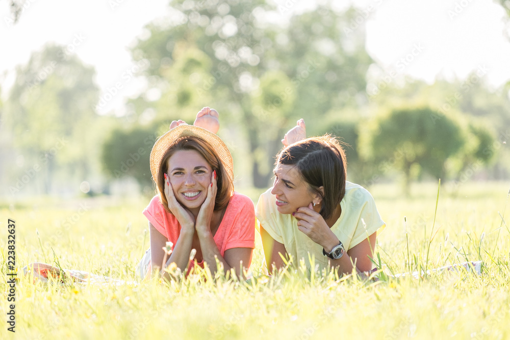 Two girl laughing on grass