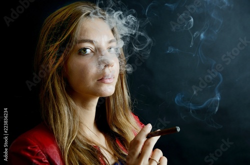 Young female smoking cigarillo