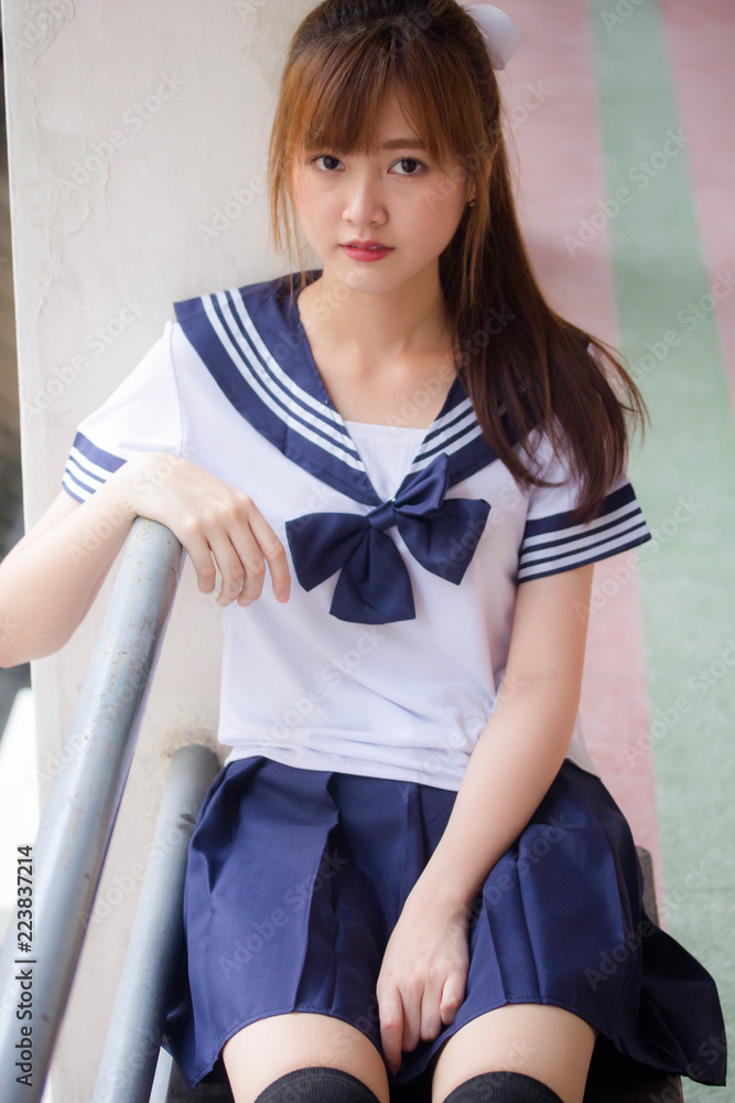 Portrait of thai teen beautiful girl in japanese student uniform happy