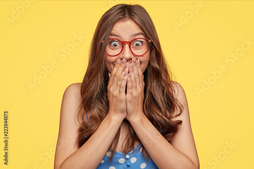 Surprised happy young girl looks with happiness at camera, cant believe in un...