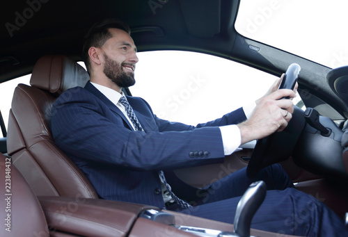 businessman sitting behind the wheel of a car