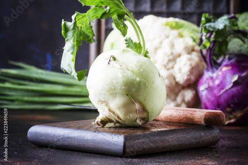 Green kohlrabi cabbage, auatumn harvest on brown table. selective focus photo