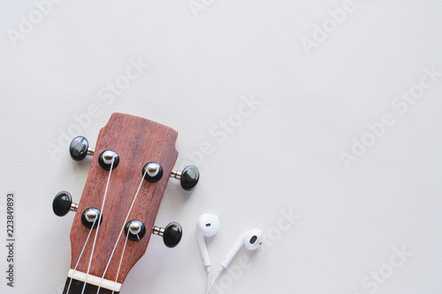 Ukulele with earphones on w...