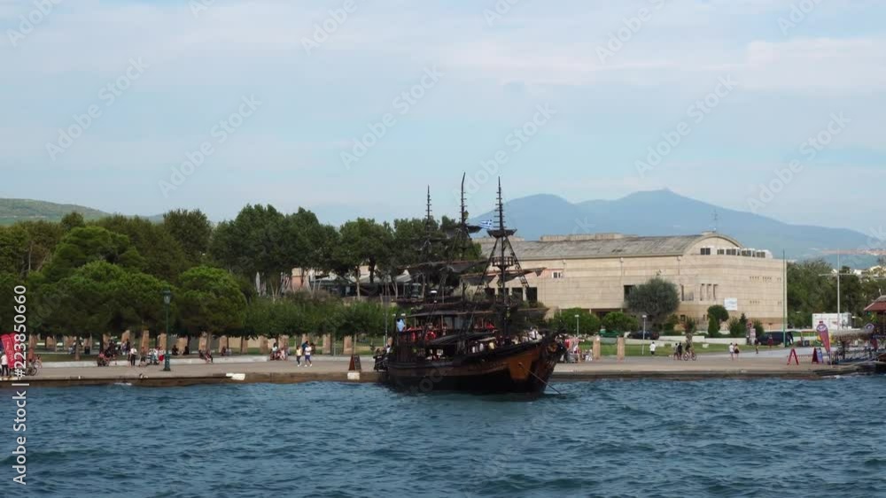 Ancient tourist attraction boats stay at small bay in calm deep blue waves in ancient Thessaloniki waterfront panorama Ancient tourist attraction boats stay at small bay in calm deep blue waves in ancient Thessaloniki waterfront panorama