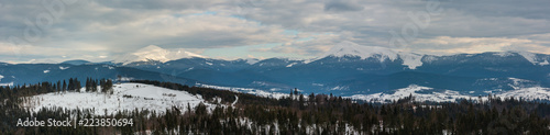 Fototapeta Naklejka Na Ścianę i Meble -  Evening winter cloudy day mountain ridge