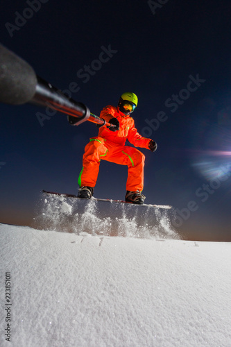 Obraz na płótnie Snowboarder making a selfie by his action camera on the top of the ski slope w salonie