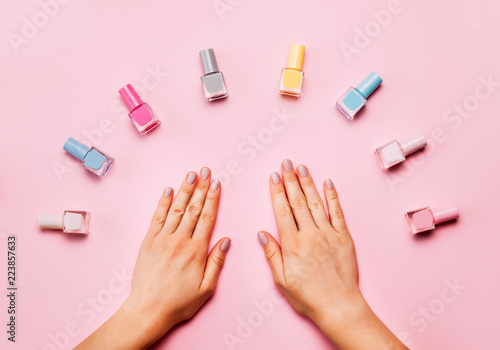 Beautiful female hands with trendy stylish manicure on pink background.