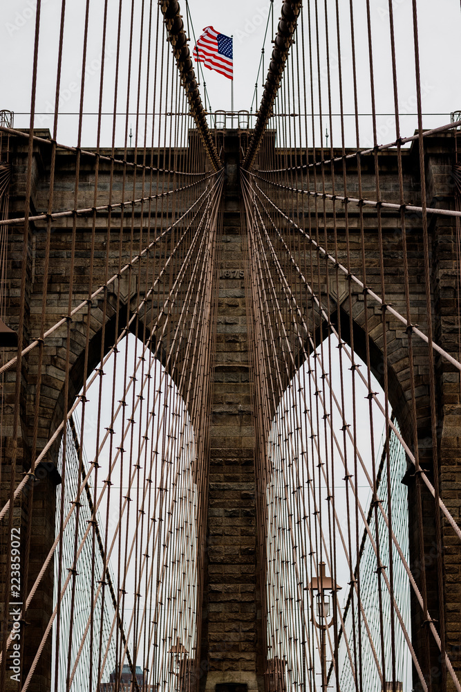 Fototapeta premium Brooklyn Bridge with the USA flag.