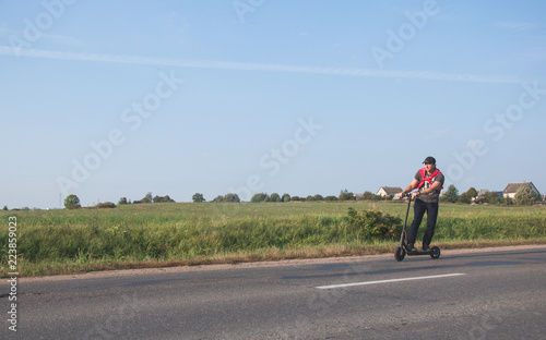 Young man riding an electric scooter