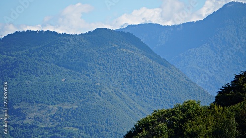 Mountain peak range landscape. Green mountain range view. Mountain peak blue sky white clouds panorama