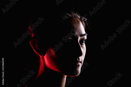 Portrait of woman in dramatic light.