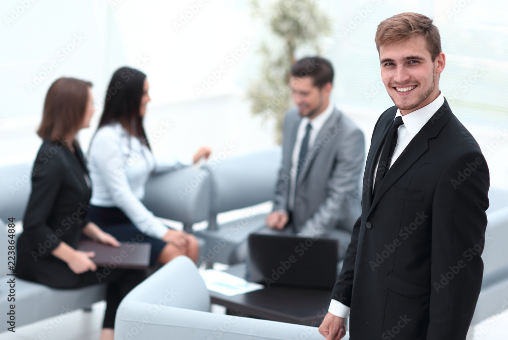 portrait of confident businessman on background of office. portrait of confident businessman on background of office.