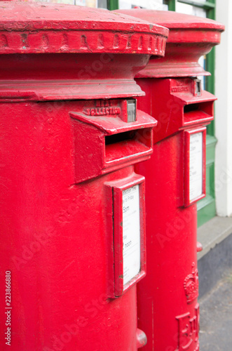 Closeup of two traditional British red mail boxes.