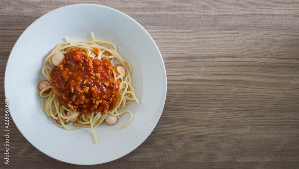 Spaghetti with Sausage Tomato Sauce on wood table. Spaghetti with Sausage Tomato Sauce on wood table.