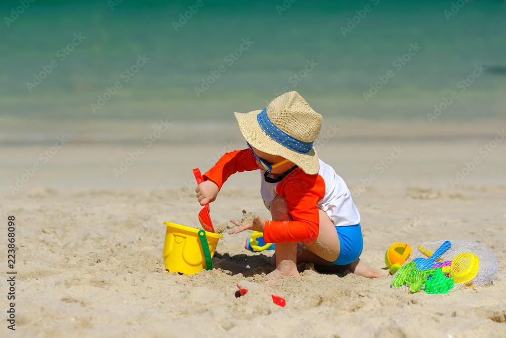 Two year old toddler playing on beach Two year old toddler playing on beach