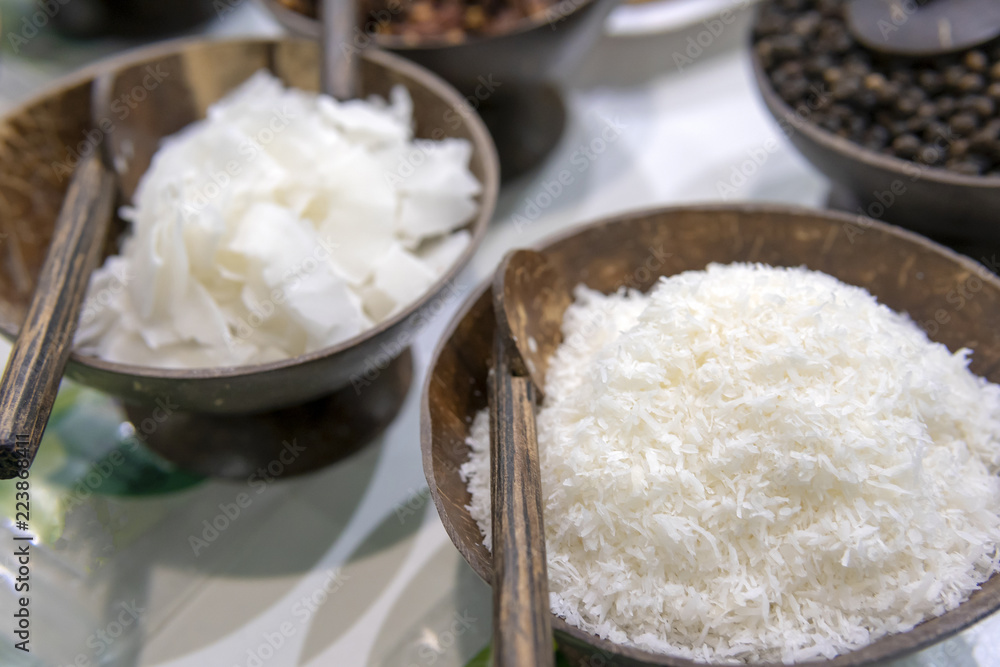 White coconut shavings in a wooden bowl.