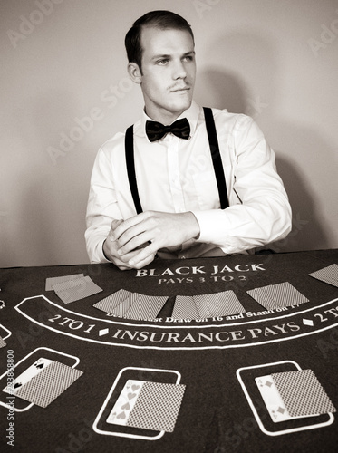 Croupier deals cards at game blackjack table