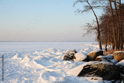 Winter landscape on the shore of a frozen lake in Eastern Finland.