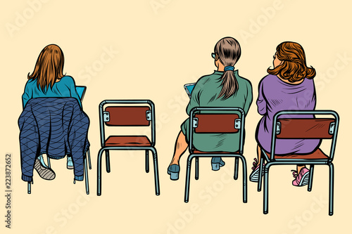 women sit back on chairs