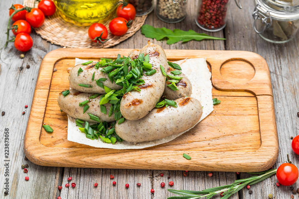 Sausages of chicken meat on a wooden table Sausages of chicken meat on a wooden table