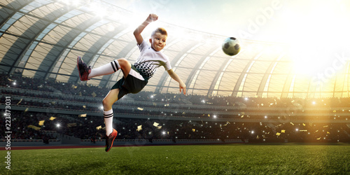children soccer player in action in stadium solo