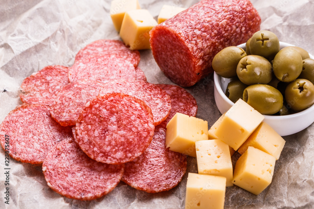 delicious sliced salami on a wooden background delicious sliced salami on a wooden background