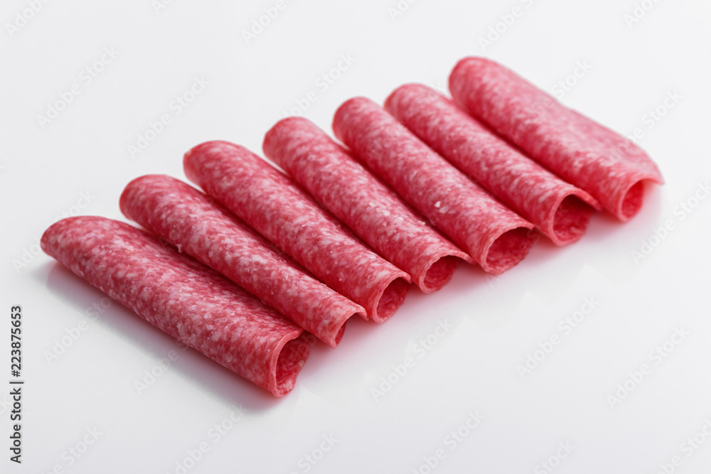 delicious sliced salami on a white background delicious sliced salami on a white background