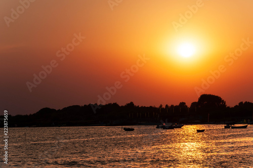 Sunset over the bay. Boats on the water.