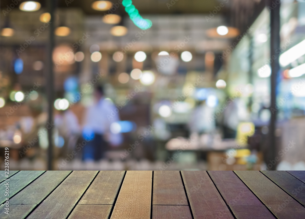 image of wooden table in front of abstract blurred background image of wooden table in front of abstract blurred background