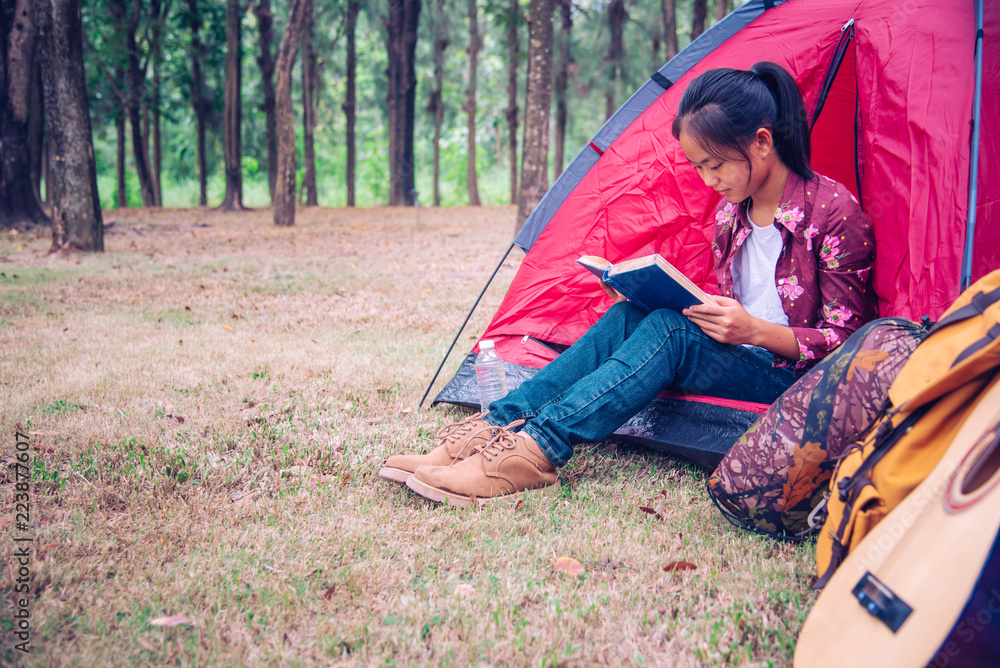 Teenagers are relaxing by reading books in the outdoor picnic area in the garden. Teenagers are relaxing by reading books in the outdoor picnic area in the garden.