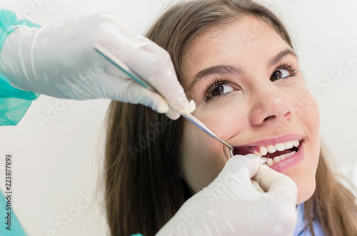 Dentist putting gauze in mouth of a patient