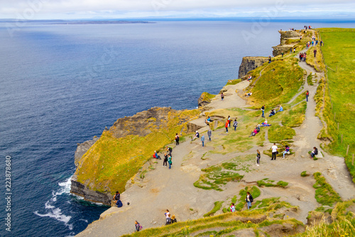 People walking over Cliffs of Moher photo