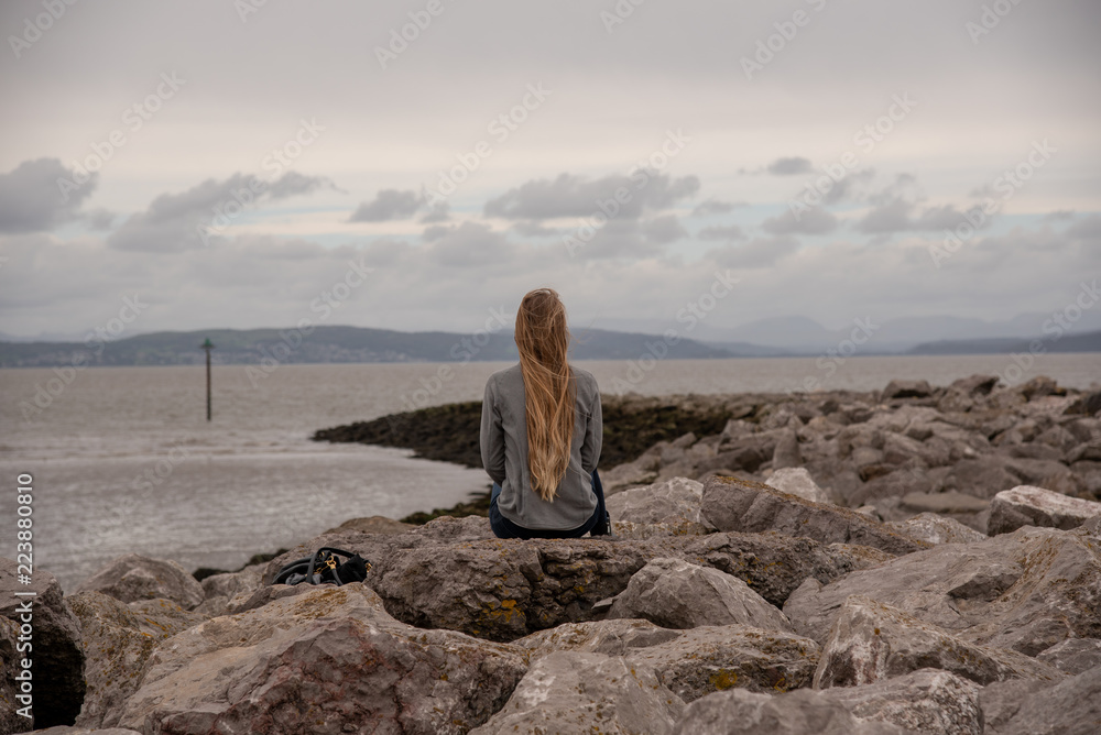 Blonde Girl from the Back at Irish Sea on Rocks