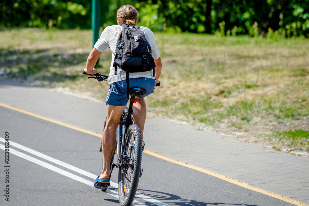 Fototapeta premium Cyclist ride on the bike path in the city Park 