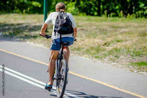 Fototapeta Naklejka Na Ścianę i Meble -  Cyclist ride on the bike path in the city Park 