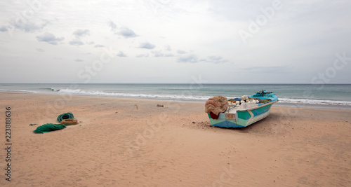 Small boat on Nilaveli beach in Sri Lanka Asia