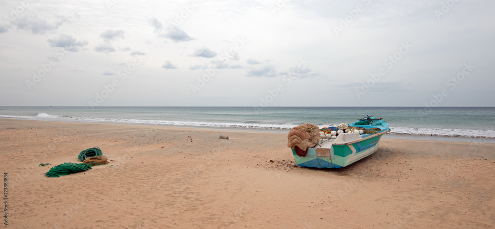 Small boat on Nilaveli beach in Sri Lanka Asia