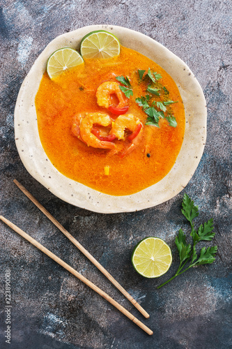 Traditional thai cuisine, Tom yum goong, Spicy shrimp soup on rustic background.Top view,flat lay. photo