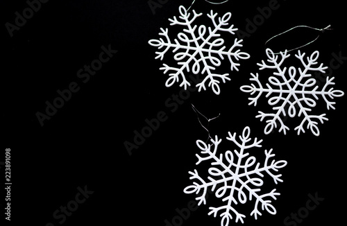 White snowflakes isolated on black background. Winter theme. Christmas and new year decotations. photo