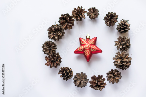 Christmas and new year composition isolated on white background. Pine cones, red star. Winter holiday decorations.