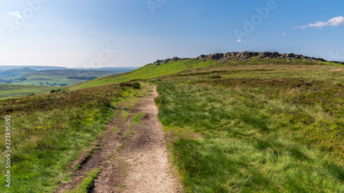 Peak District landscape, walking towards Stanage Edge near Hathersage in the East Midlands, Derbyshire, England, UK