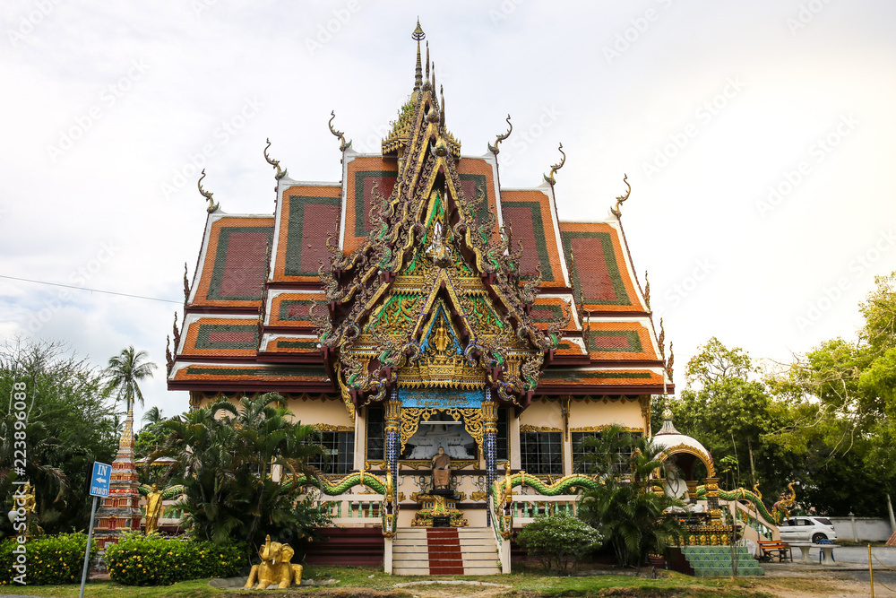 The Thai temple in Wat Plai Laem in Samui Island Thailand, with the statue of the serpent king and elephant.