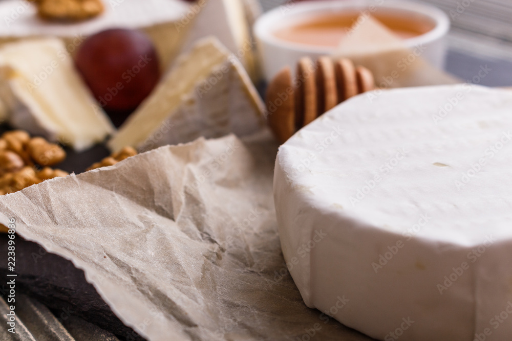 delicious creamy camembert cheese on a wooden rustic background delicious creamy camembert cheese on a wooden rustic background
