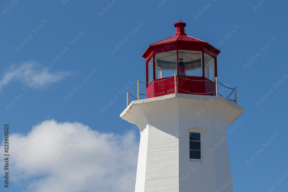 Peggy's Cove Lighthouse, summer sky clouds, blue sky.