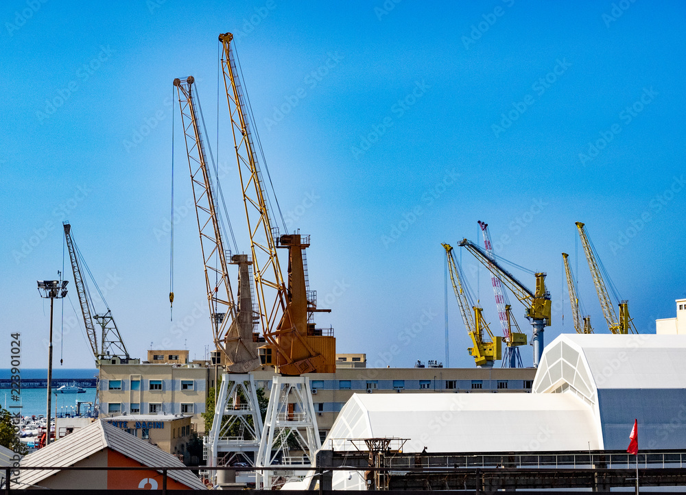 cranes in the port of Genoa for the loading and unloading of merchant ships. Italy