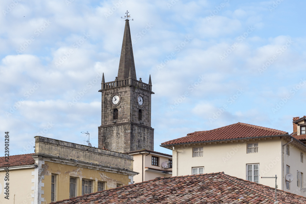 Fototapeta premium bell tower on the roofs of some buildings, Comillas, Cantabria, Spain