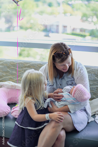 family visiting newborn baby in hospital