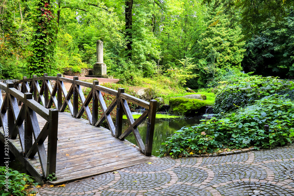 Beautiful little wooden bridge across river in the Sofia Park, Uman, Ukraine Beautiful little wooden bridge across river in the Sofia Park, Uman, Ukraine