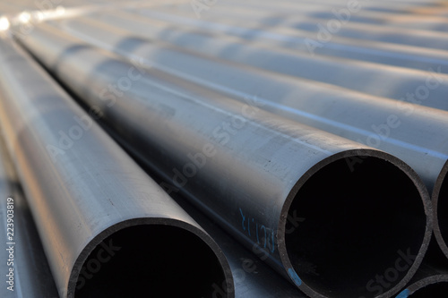 Plastic pipes in stock of finished products stacked in packs photo