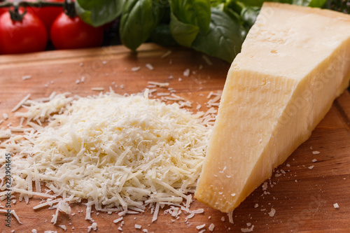 fragrant grated Parmesan on a wooden slicing board